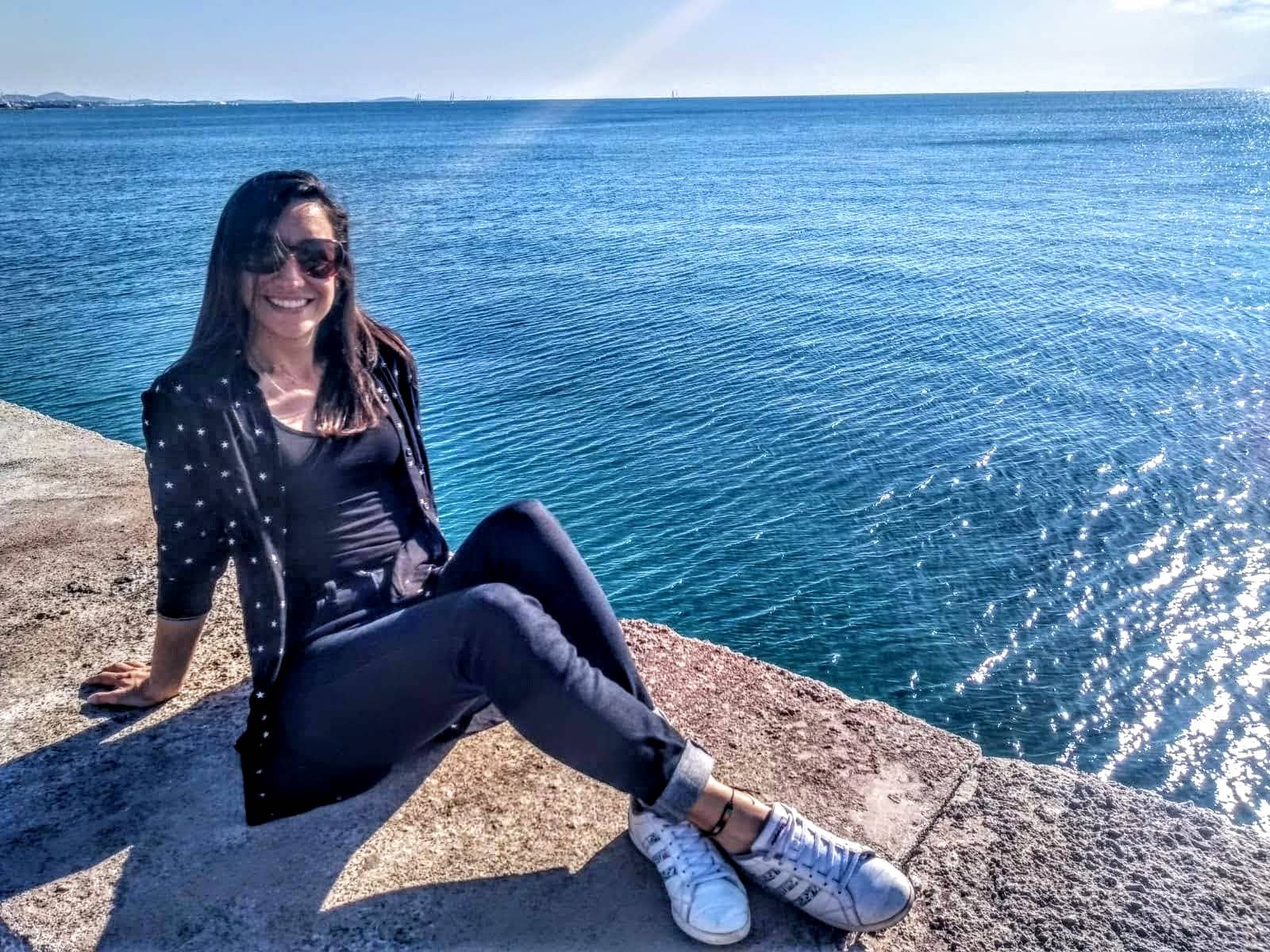 Carolina sentada a lado del mar Mediterráneo en Flisvos Marina , Athenas.

Esta no es una foto en bikini! Es una representación de su cambio de vida.

Su sonrisa y expresión relajada son muestra de su satisfacción por dedicar su vida a ayudar a las personas a vivir vidas más saludables.
